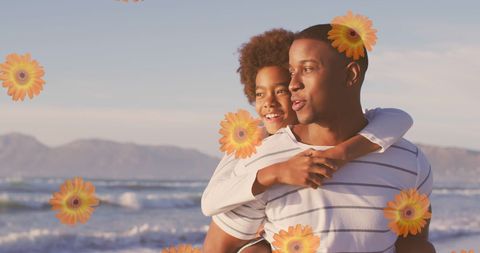 Joyful Father and Son Embracing on Beach with Floral Touch