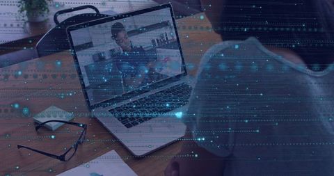 Remote meeting at home desk with man watching laptop, workspace and digital data overlay