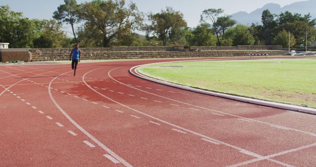 Athlete Running on Outdoor Track on Sunny Day - Download Free Stock Images Pikwizard.com