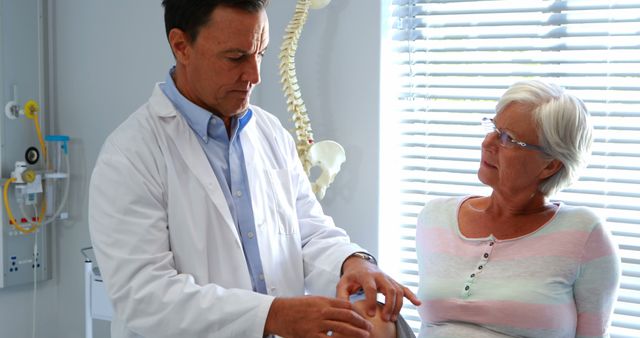 Doctor Examining Senior Woman's Arthritis in Medical Office - Download Free Stock Images Pikwizard.com