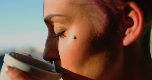 Close-Up of Woman with Piercings Drinking Coffee - Download Free Stock Images Pikwizard.com