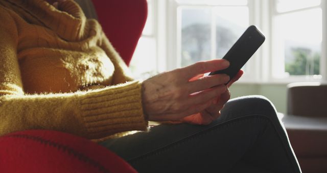 Elderly Person Using Smartphone in Sunlit Room - Download Free Stock Images Pikwizard.com