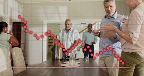 Older adults socializing and holding drinks around dining table with chart overlay
