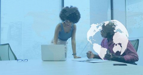Collaborating on global strategy with digital world map overlay in modern boardroom