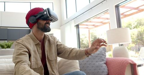 Man with turban using vr headset in modern living room