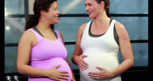 Two Pregnant Women Smiling and Chatting at Gym - Download Free Stock Images Pikwizard.com