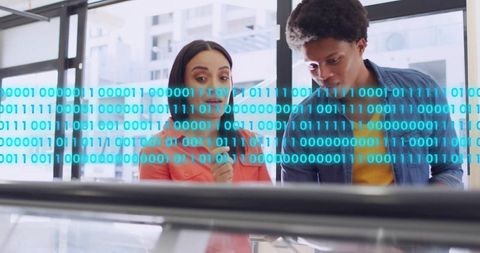 Diverse professionals collaborating over interactive data display with binary code overlay