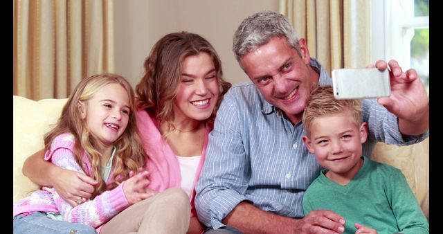 Happy Family Taking Selfie Together on Living Room Sofa - Download Free Stock Images Pikwizard.com