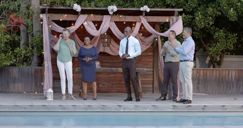 Seniors Joyfully Celebrating at Poolside Garden Gathering