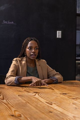 Businesswoman in boardroom discussing strategy