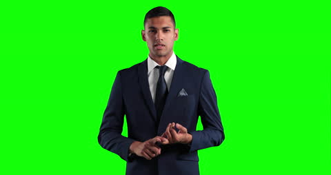 Confident Businessman Presenting in Professional Attire on Green Screen