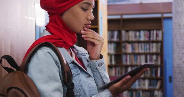 Young Student in Library Using Digital Tablet - Download Free Stock Images Pikwizard.com