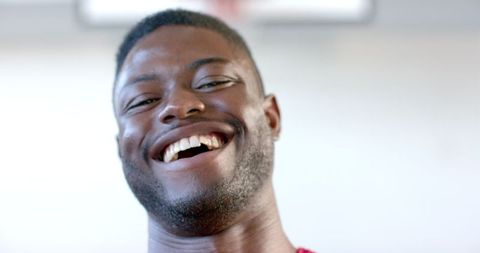 Joyful african american athlete smiling broadly in slow motion