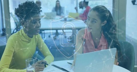 Women Collaborating in Modern Office Setting with Digital Interface