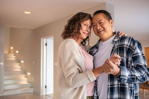 Senior Couple Enjoying Dance in Elegant Home Setting