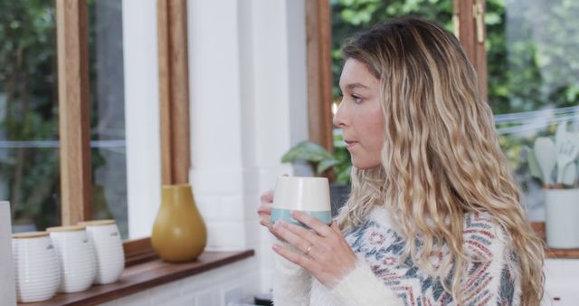 Woman Relaxing Indoors with a Warm Beverage in Hands - Download Free Stock Images Pikwizard.com