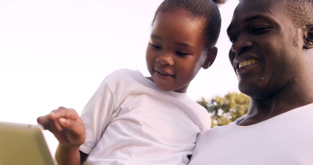 Father and Daughter Using Digital Tablet Outdoors Smiling - Download Free Stock Images Pikwizard.com