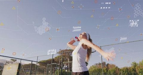 Female Tennis Player Serving on Outdoors Court