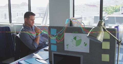 Thoughtful Financial Analyst Analyzing Data at Modern Office