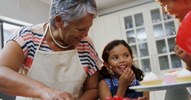 Grandmother baking with granddaughter in kitchen, joyful family time - Download Free Stock Images Pikwizard.com