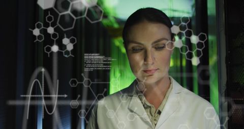 Female engineer analyzing data in high-tech server room
