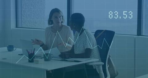 Women executives analyzing charts in modern office