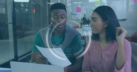 Focused Colleagues Analyzing Documents in Modern Office