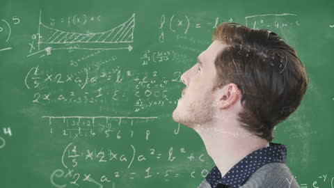 Young Businessman Analyzing Complex Mathematical Equations on Chalkboard