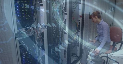 Woman IT technician inspecting server rack with tablet in datacenter, network cables