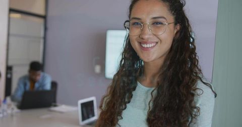 Smiling Hispanic Woman in Professional Meeting Room Setting