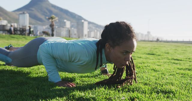 Athletic Woman Performing Push-ups on Grass in Outdoor Park - Download Free Stock Images Pikwizard.com