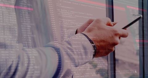 Man with Smartphone Engaging with Code in Modern Office