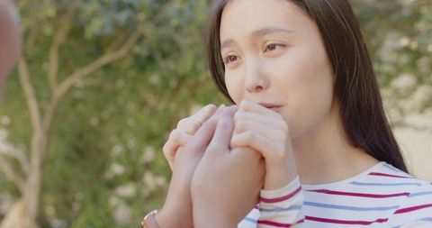 Mother and daughter sharing emotional moment outdoors