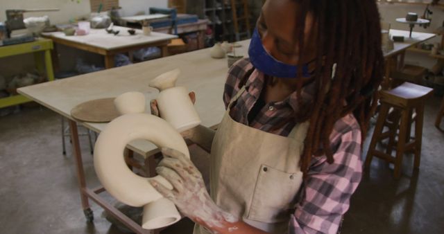 Female Artist with Dreadlocks Working on Ceramic Sculpture in Studio - Download Free Stock Images Pikwizard.com