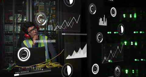 Technician monitoring data center analytics in safety gear
