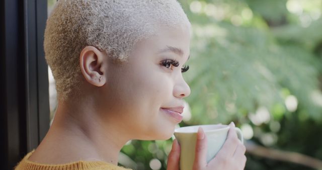 Young Woman with Platinum Blonde Hair Enjoying Coffee by Window - Download Free Stock Images Pikwizard.com