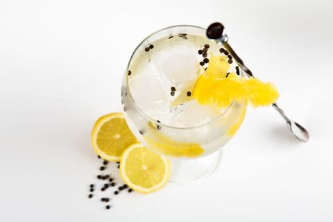 Refreshing gin and tonic with lemon and pepper garnish