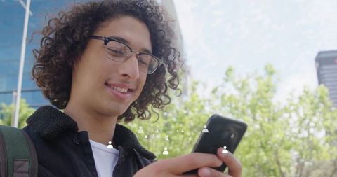 Smiling Young Student Checking Smartphone Outdoors