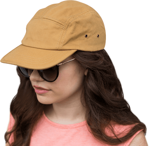 Chic woman wearing sunglasses and tan cap on transparent background