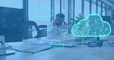 Adjusting headphones working with neon cloud collaboration visuals in open-plan office