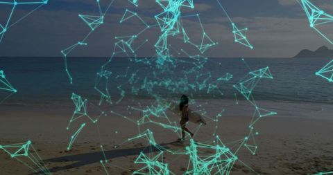 Surfer walking on tropical beach carrying surfboard at golden hour with turquoise network