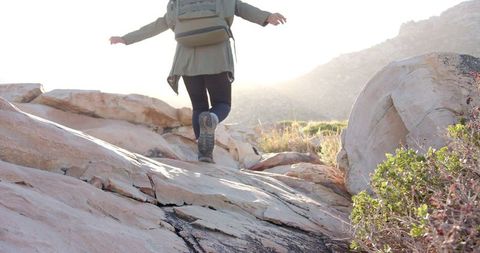 Woman Hiking Rocky Terrain in Morning Light