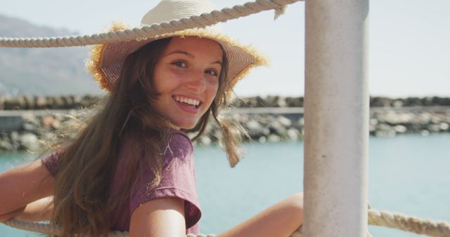 Smiling Young Woman Wearing Sun Hat by the Seaside - Download Free Stock Images Pikwizard.com