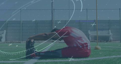 Male Soccer Player Stretching on Field with Digital Overlay