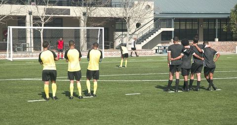 Soccer Players Practicing Free Kick at School Field Together