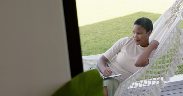 Relaxed Woman Writing in Journal While Lying on Hammock - Download Free Stock Images Pikwizard.com