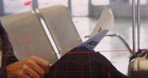 Businessman reading newspaper with digital data overlay