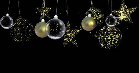 Elegant glass baubles and star ornaments on black background