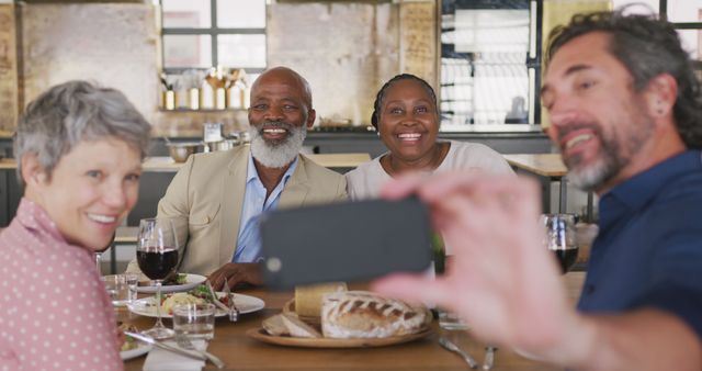 Friends Enjoying Meal and Taking Selfie at Restaurant - Download Free Stock Images Pikwizard.com