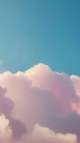 Vertical video panning over pastel cumulus clouds drifting and rising in blue sky